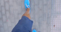Timelapse of male feet walking on sidewalk
