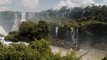Panoramic View Of Iguazu Falls And River On Sunny Day In Parana, Brazil. wide shot, slow motion