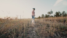 Cute golden retriever pup with its owner woman walking countryside. Happy dog spending good time on nature, forest background. Cute doggy. Hunting breed. High quality 4k footage