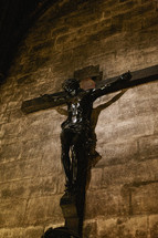 A crucifix hanging on a stone wall