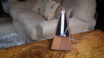 Fast Metronome on Top of a Walnut Veneer Table in a Drawing Room