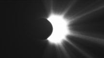 Sun rays of light, moon covering the sun during Total Solar Eclipse, Black and white.	