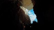 blue sky seen from a crack in the cave