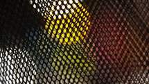 Bokeh city lights through wire grate - background