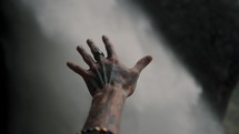 Selective Focus of Tattooed Hand Reaching Pailon Del Diablo Waterfall In Baños De Agua Santa, Ecuador. 