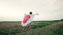 Cute little boy - Japanese patriot kid runs with national flag. Japan, Labor Thanksgiving Day, Sports Day, Children's, Showa Day. High quality 4k footage