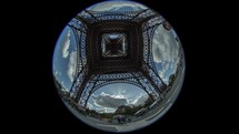 Timelapse shot of people walking and clouds sailing View under Eiffel Tower