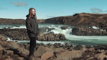 a woman near a waterfall in Iceland 