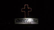 A "Christ is the Answer" sign along a busy highway at night