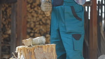 man with an ax chopping wood 
