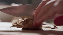 A Female's Hands Cutting Mushrooms - Close Up