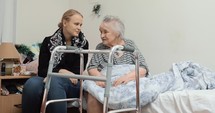 Adult granddaughter visiting elderly grandma in the hospital