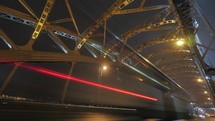 Timelapse of car traffic on the bridge at night