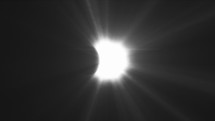 Rays of sun-light, moon covering the sun during Total Solar Eclipse. Black and white	