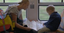 Mother and child with map traveling by train