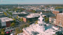 aerial view over a downtown area and courthouse 