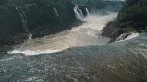 River Of Iguazu National Park Through Steep Mountains In Brazil, South America. Slow Motion Shot