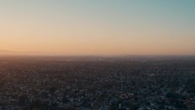 aerial view over suburbs of a city at sunset 