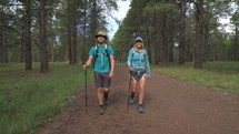 A young couple hiking together on a forest trail