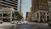 time-lapse of cars and pedestrians moving on city streets and sidewalks 