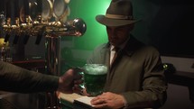 Investigator Drinks Green Beer in a Pub 