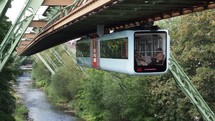 WUPPERTAL, GERMANY - Wuppertaler Schwebebahn (meaning Wuppertal Suspension Railway) above River Wupper is the oldest electric elevated railway with hanging cars in the world