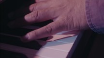 a man playing a digital keyboard 