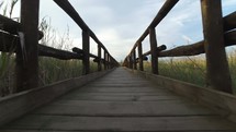 Wooden Footbridge Crosses The Swamp