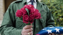 Flowers And Folded Flag To Donate To The Deceased Soldier In American Cemetery