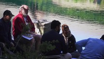 men's group discussing scripture outdoors 
