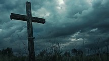 Wooden cross of Calvary in grass field on dark cloudy day