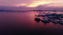 boats in a bay under a purple sunset 