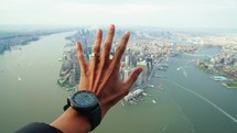 Helicopter tour over New york city with hands reaching for manhatan aerial view. Experience on the nyc sky. Concept about travel and transportation