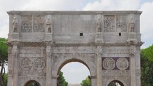 Arch of Constantine on background of blue sky on sunny day, located between coliseum and Arch of Titus on Roman road, built to celebrate triumph of
