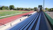 football field and track with mountains in the background 