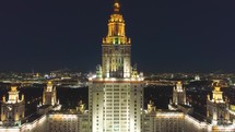  aerial night view of illuminated russian skyscraper with city lights in the background 4k drone shot