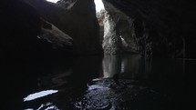 Man swimming alone in dark cave