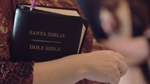 woman holding a Spanish Bible, Santa Biblia 