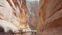 Slot Canyon with Adventurous group Hiking in Zions National Park, Utah
