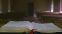Bible on an alter in an empty chapel 