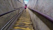 a boy running up steps 