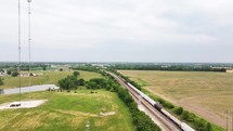 Aerial footage of a moving freight train on the railroad shows a country landscape.