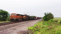 Low-angle view of freight training moving on railroad tracks in the country.