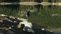 Person standing near a lake 