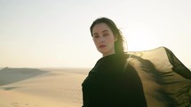 Portrait of Young beautiful girl in traditional Abaya dress on the dunes in the desert of Qatar. 4K Slow Motion
