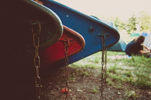 chained canoes and tents 