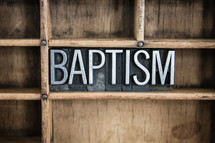 word baptism in blocks on a shelf