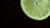 Lemon slice plunging into water
