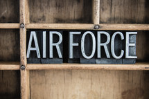 word air force in blocks on a bookshelf 