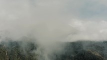 Mist And Clouds At Tungurahua Volcano In Baños de Agua Santa, Ecuador - aerial drone shot	